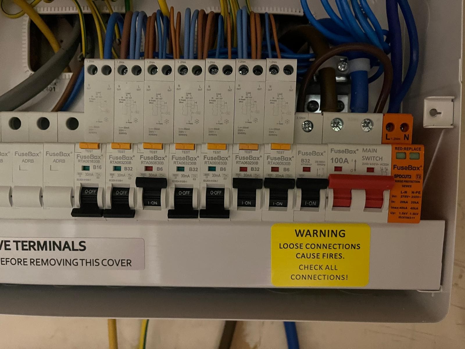 Close-up of a consumer unit with surge protection device, photographed during fault diagnosis.